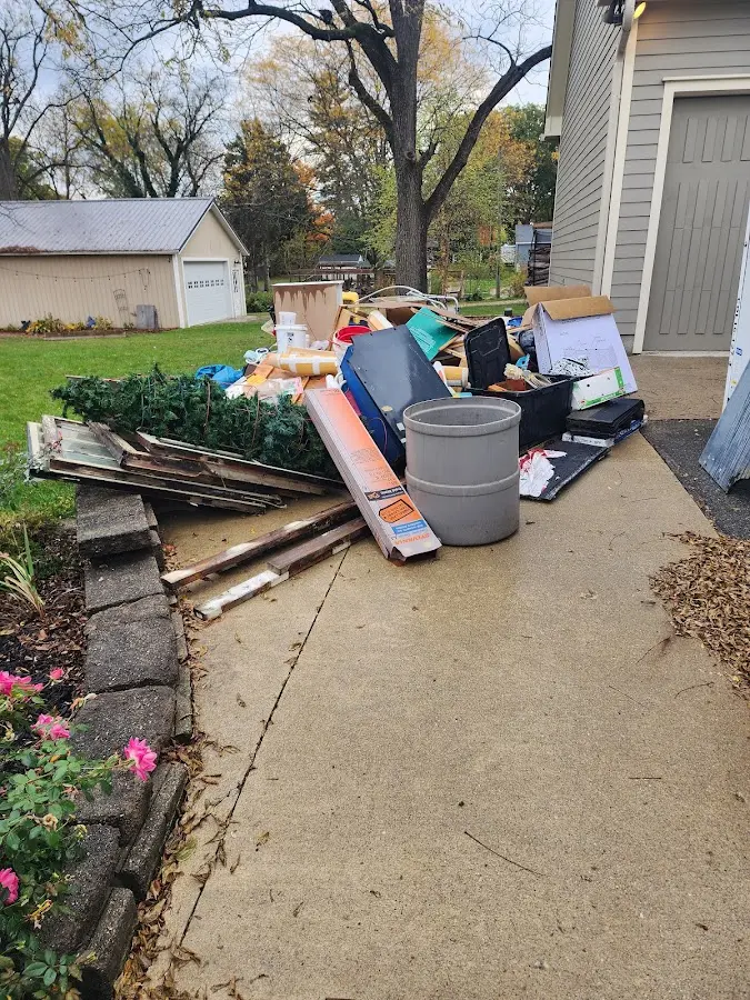 Dumpster being loaded with debris for Estate Cleanout Dumpster Rental in Riverdale Park